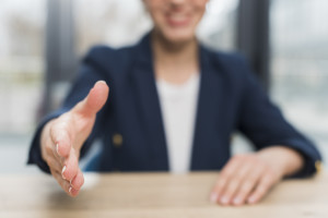 front-view-defocused-woman-offering-hand-shake-after-being-hired (1)